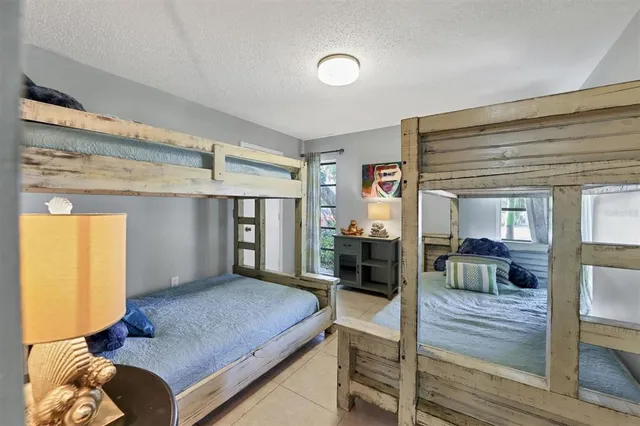 a bedroom with a bed and a view of living room