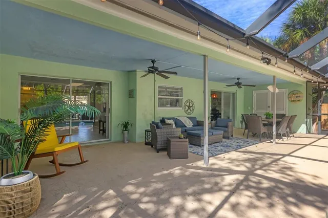 a view of a patio with table and chairs and potted plants