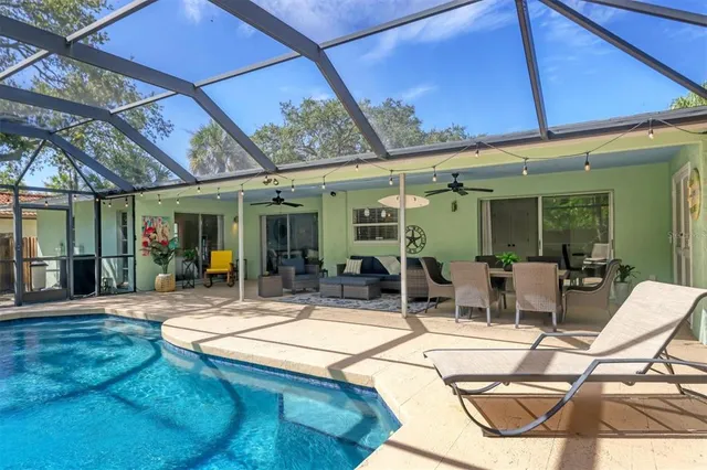a view of a patio with a table and chairs under an umbrella