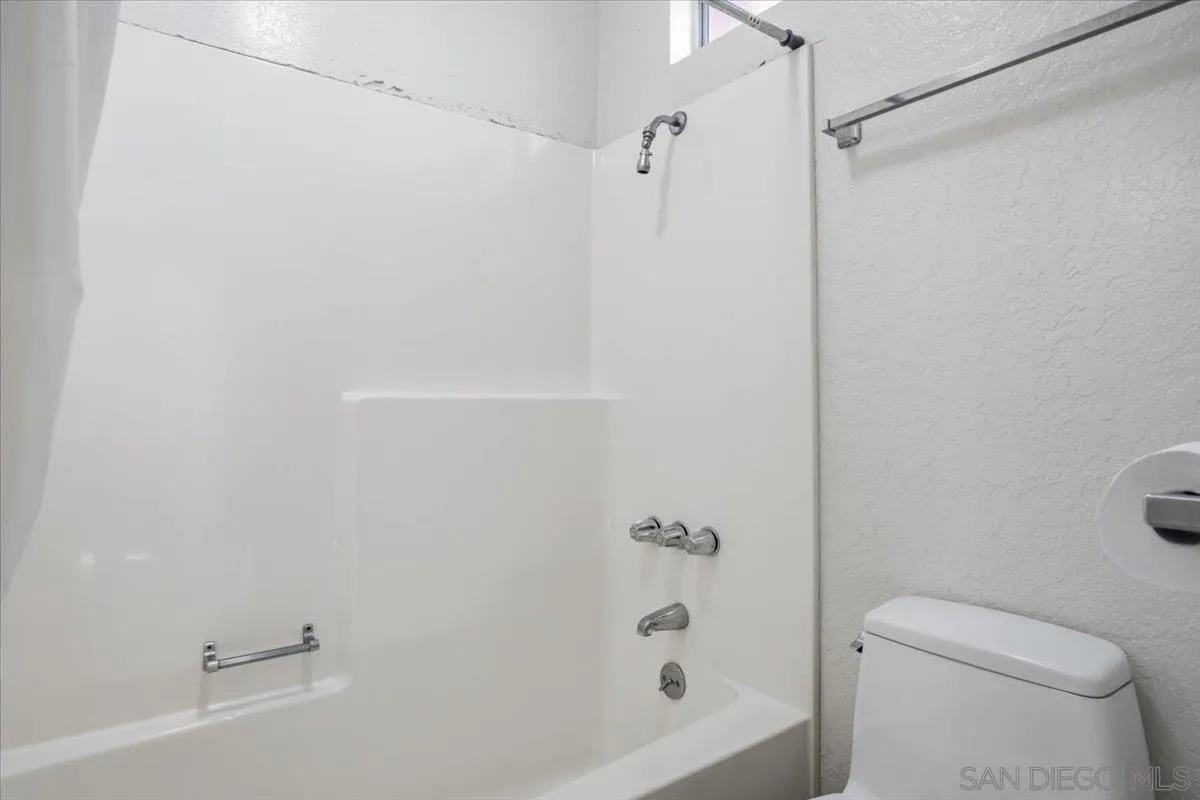 3711 Racine Road San Diego, CA 92115 - Photo 22 of 44 a bathroom with a bathtub and a toilet