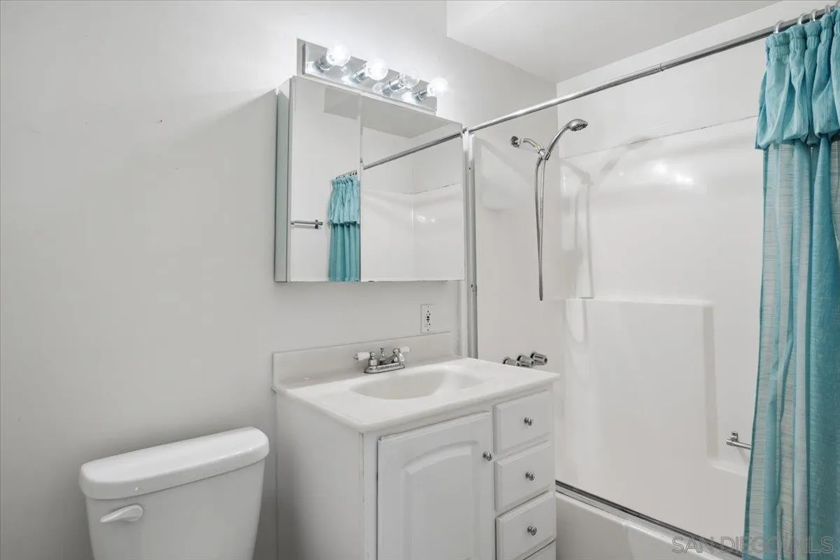 3711 Racine Road San Diego, CA 92115 - Photo 3 of 44 a bathroom with a sink a toilet and shower