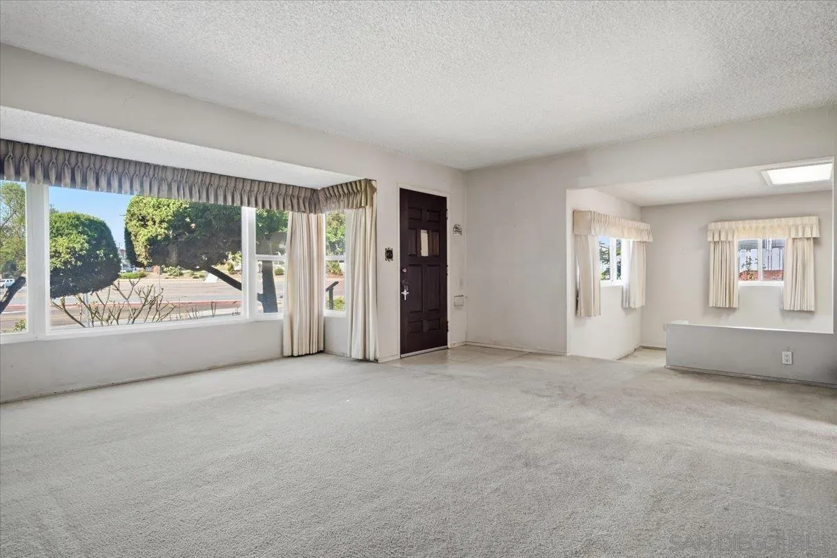 3711 Racine Road San Diego, CA 92115 - Photo 6 of 44 an empty room with furniture and a large window
