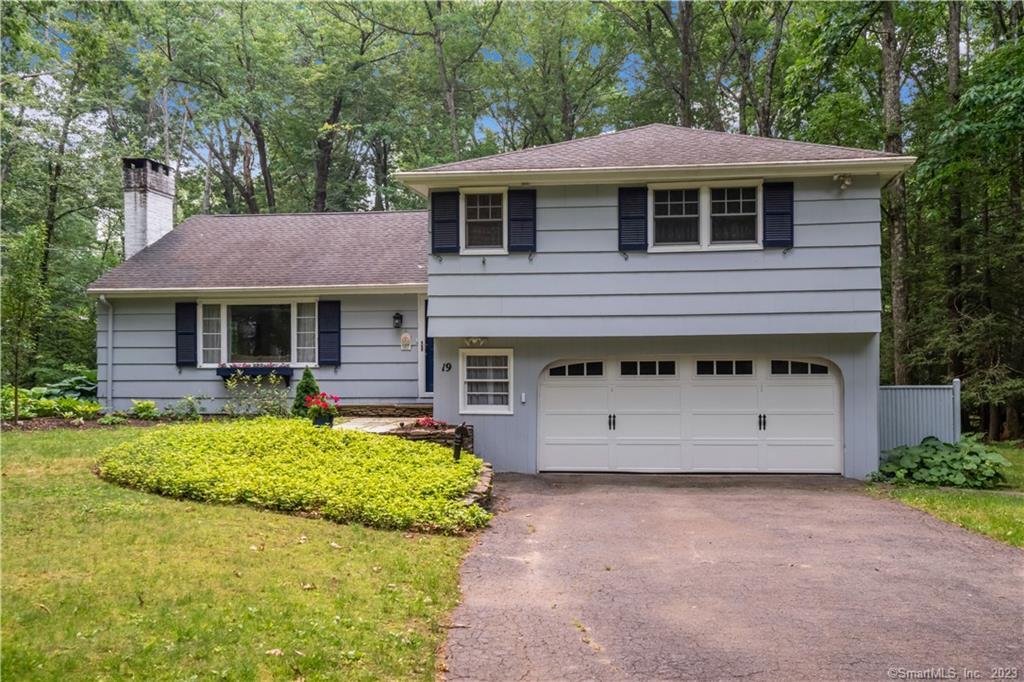 19 Sunset Hill Road Simsbury, CT 06070 - Photo 1 of 1 a front view of a house with a yard and garage