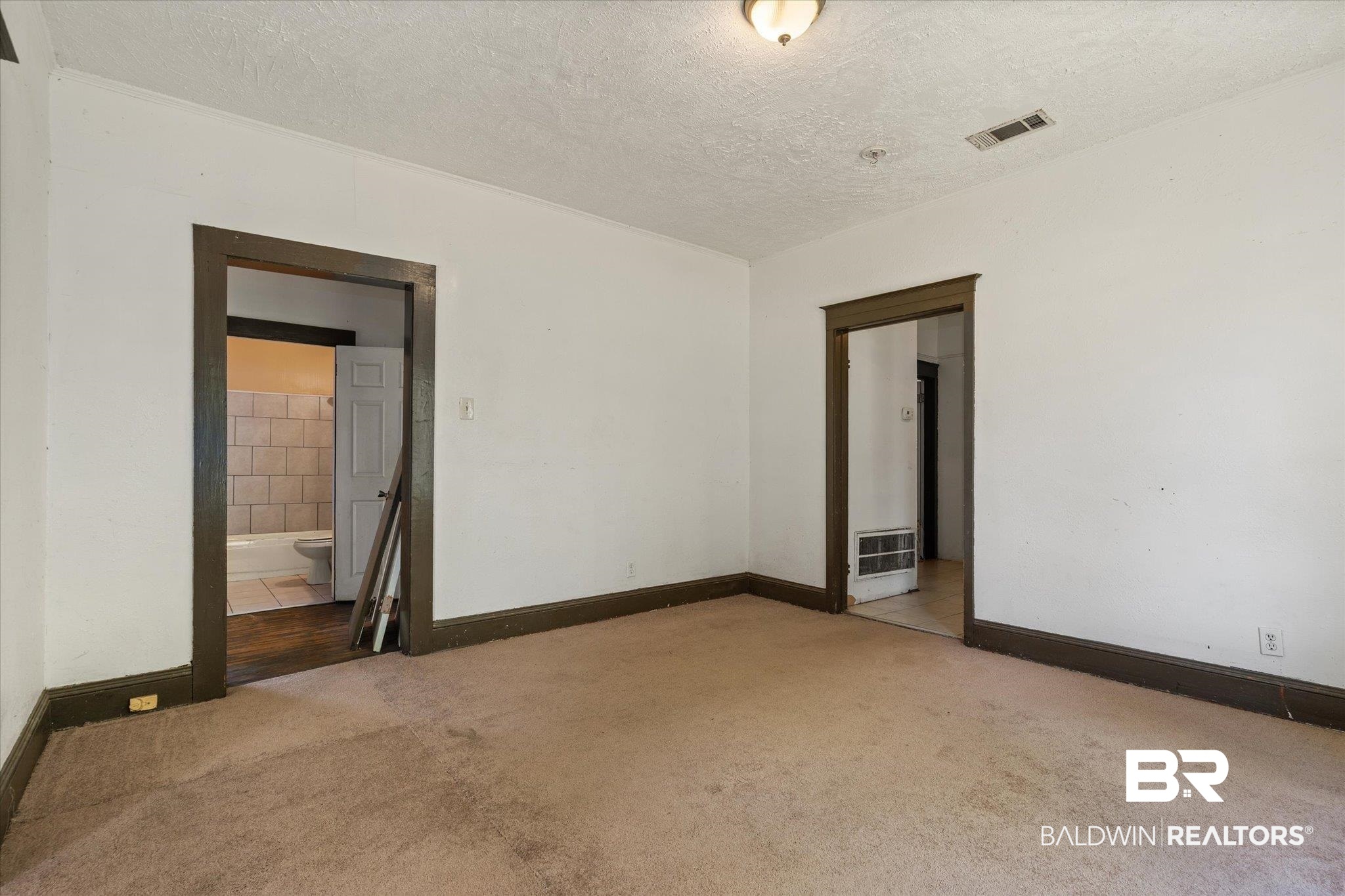 672 Burden Street Mobile, AL 36607 - Photo 4 of 20 Carpeted empty room with a textured ceiling and baseboards