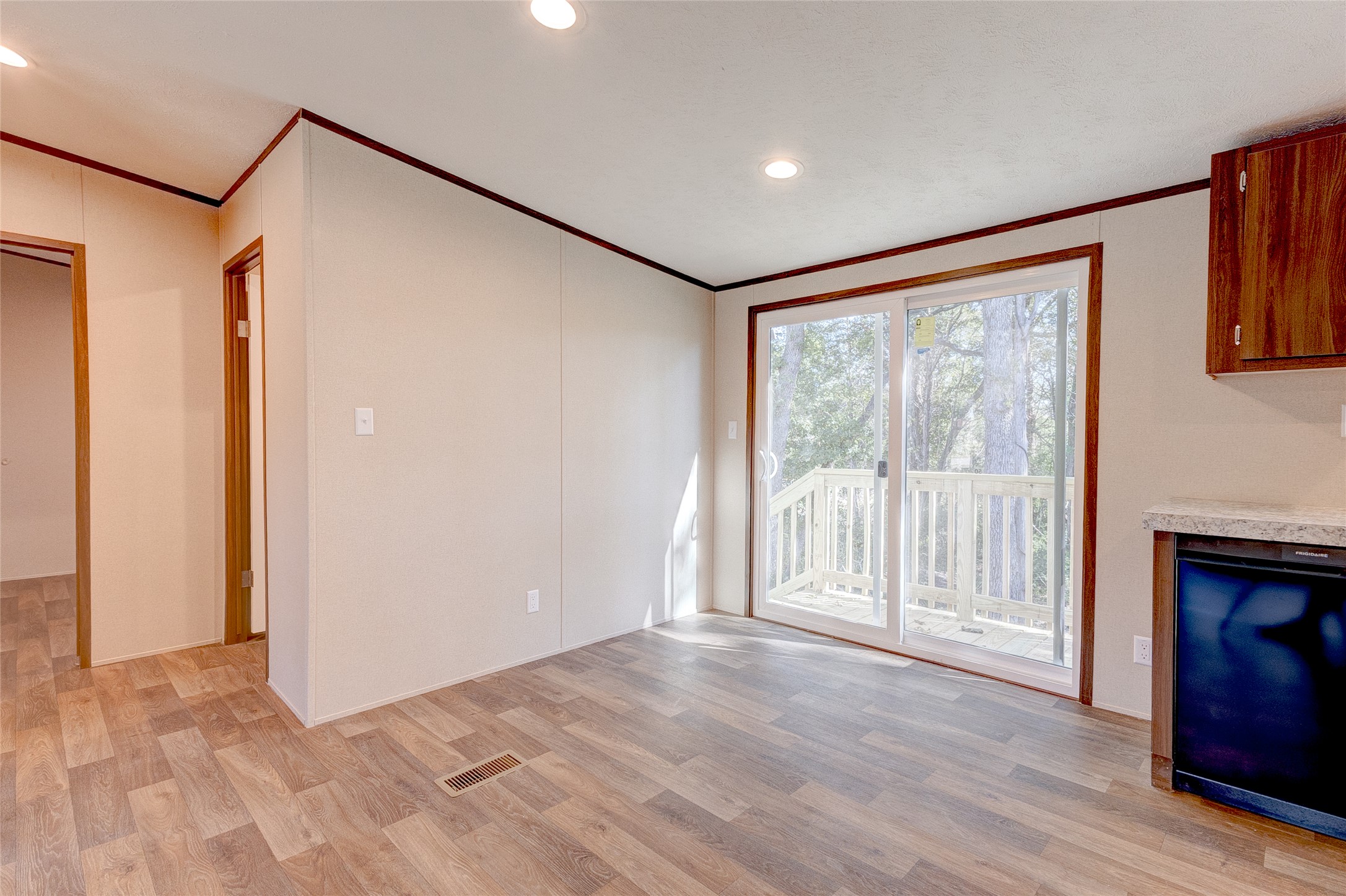 107 Los Cueva Road Elgin, TX 78621 - Photo 19 of 31 Unfurnished living room featuring ornamental molding, light wood-type flooring, and recessed lighting