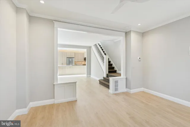 a view of entryway and hall with wooden floor