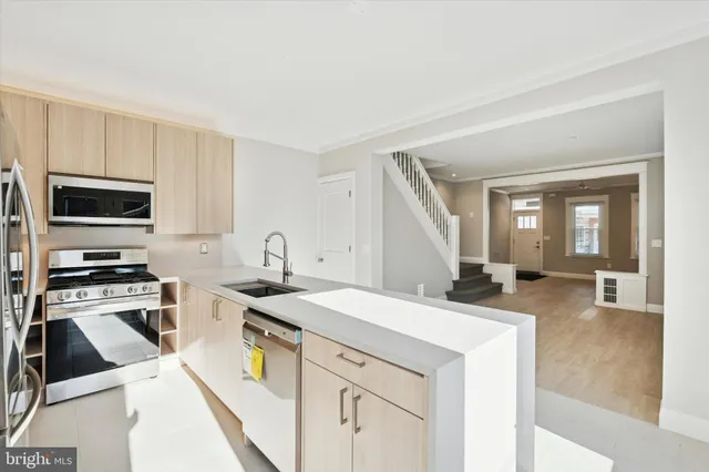 a kitchen with a sink stove and cabinets