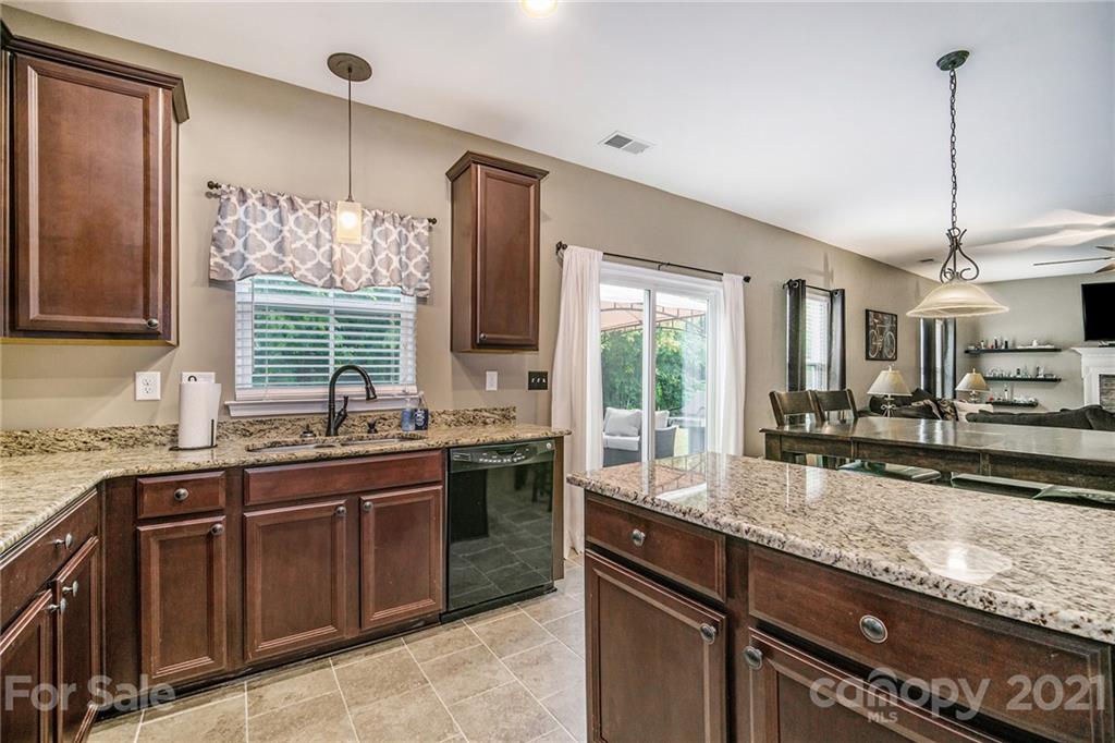 7678 West Berkeley Road Denver, NC 28037 - Photo 13 of 29 a kitchen with stainless steel appliances granite countertop a sink stove and window