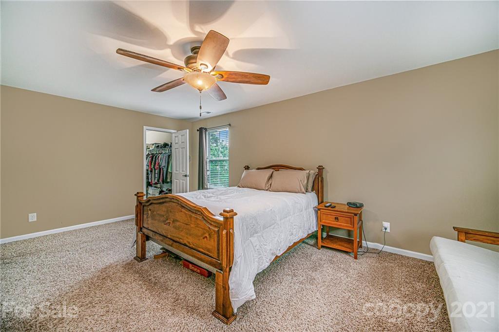 7678 West Berkeley Road Denver, NC 28037 - Photo 20 of 29 a bed room with a bed and a ceiling fan