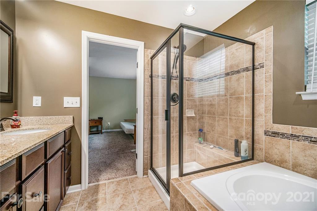 7678 West Berkeley Road Denver, NC 28037 - Photo 23 of 29 a bathroom with a sink and a mirror