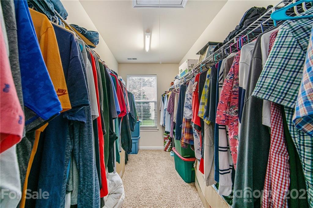 7678 West Berkeley Road Denver, NC 28037 - Photo 24 of 29 a view of walk in closet with clothes