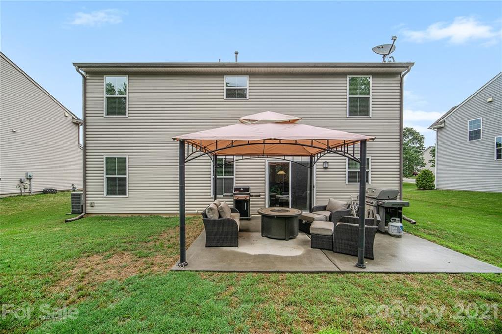7678 West Berkeley Road Denver, NC 28037 - Photo 28 of 29 a view of a house with backyard sitting area and garden