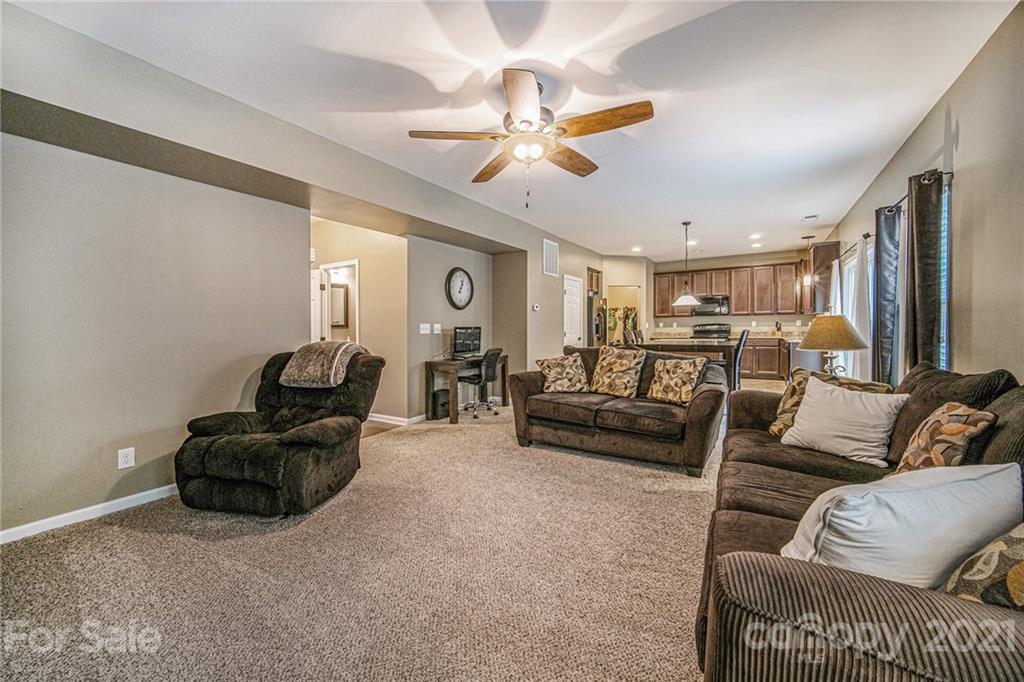 7678 West Berkeley Road Denver, NC 28037 - Photo 8 of 29 a living room with furniture and a chandelier