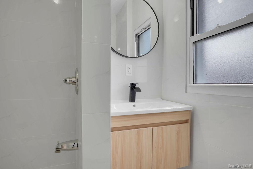 173-62 103rd Road Queens, NY 11433 - Photo 11 of 23 a bathroom with a sink and a mirror