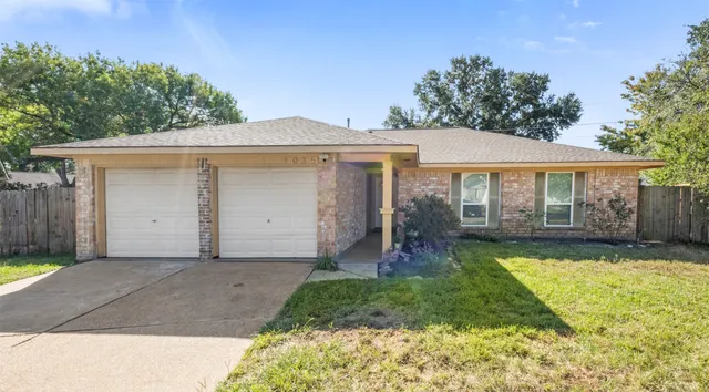 a view of a house with a yard patio and a small yard