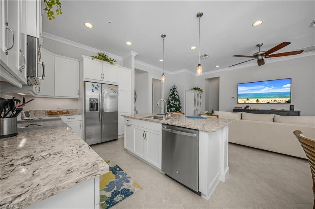 6552 Dominica Drive, Unit 101 Naples, FL 34113 - Photo 50 of 50 a kitchen with stainless steel appliances granite countertop a sink a stove and a refrigerator
