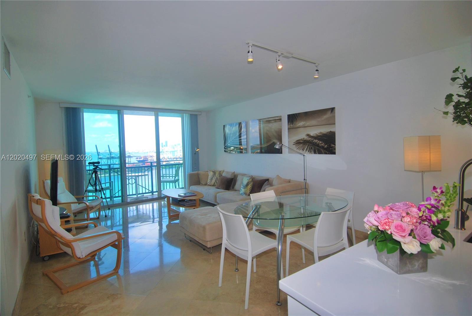 90 Alton Road, Unit 2708 Miami Beach, FL 33139 - Photo 2 of 10 a living room with furniture and a floor to ceiling window
