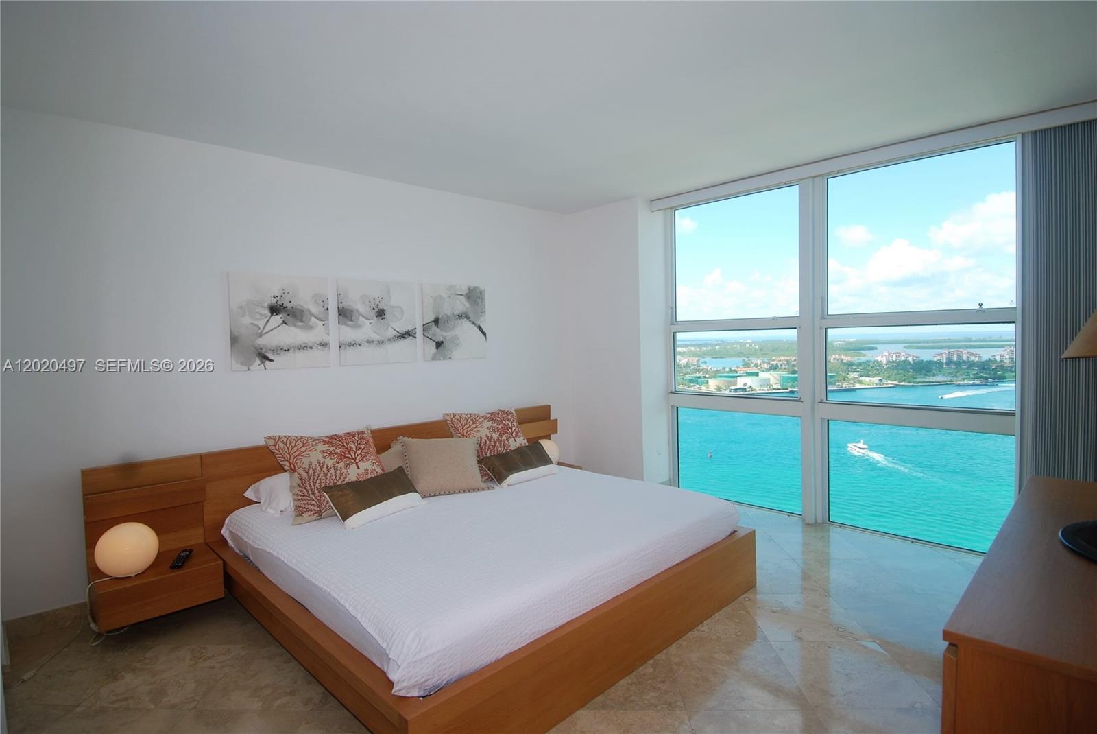 90 Alton Road, Unit 2708 Miami Beach, FL 33139 - Photo 4 of 10 a bedroom with a bed and window