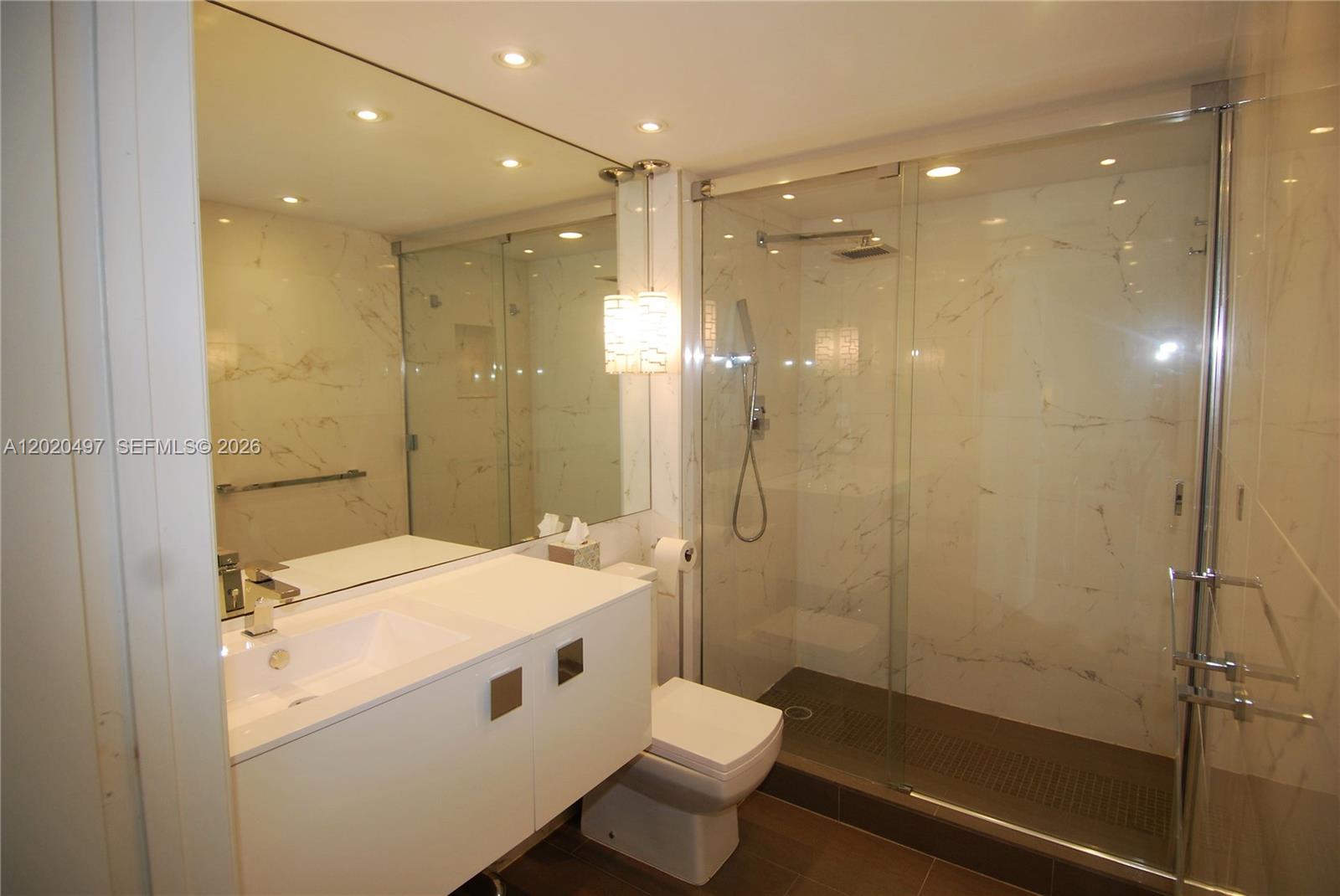 90 Alton Road, Unit 2708 Miami Beach, FL 33139 - Photo 5 of 10 a bathroom with a sink a toilet and shower