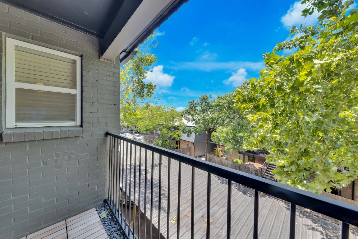 2020 South Congress Avenue, Unit 1224 Austin, TX 78704 - Photo 17 of 26 a view of a balcony with wooden floor and fence
