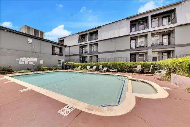 a view of outdoor kitchen and swimming pool