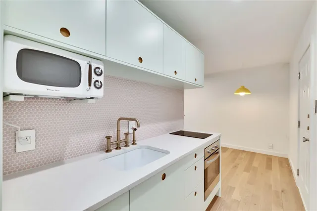 a kitchen with a sink and a microwave