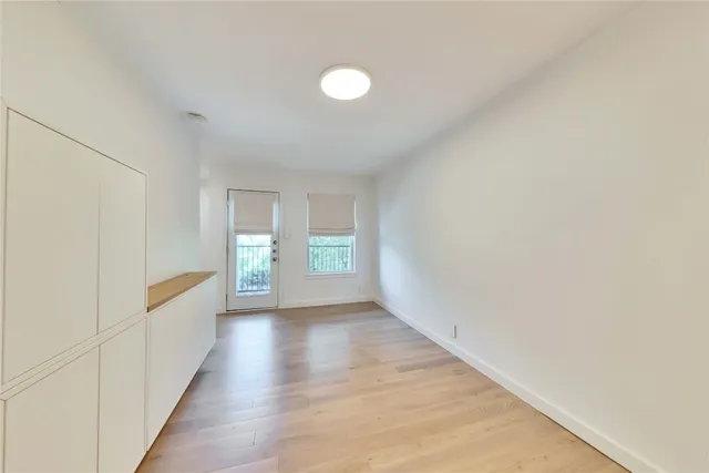 a view of a hallway with wooden floor