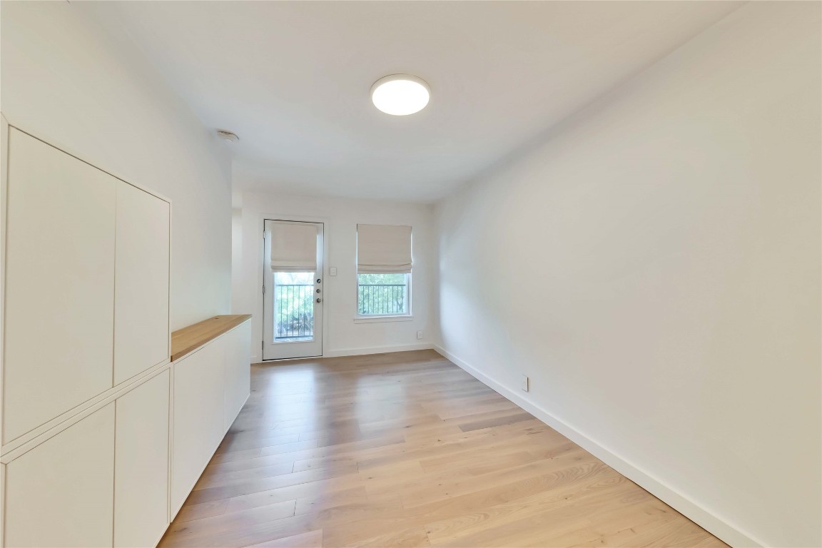 2020 South Congress Avenue, Unit 1224 Austin, TX 78704 - Photo 9 of 26 a view of a hallway with wooden floor