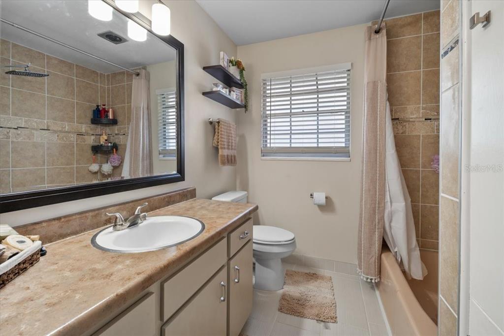 7422 County Road 231 Lake Butler, FL 32054 - Photo 34 of 57 a bathroom with a granite countertop sink toilet a mirror and shower