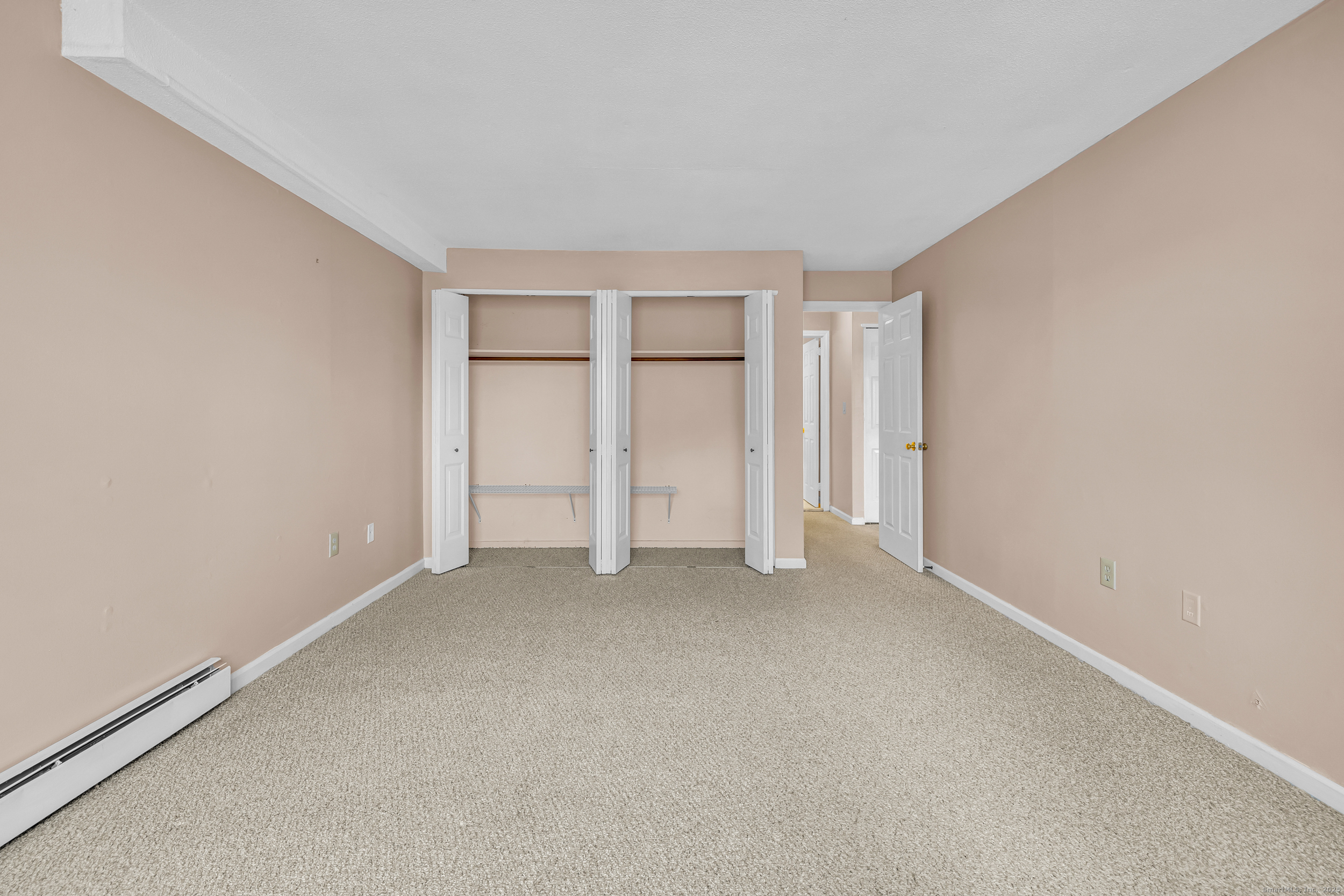 38 Rambling Brook Lane, Unit A2 Glastonbury, CT 06033 - Photo 13 of 23 an empty room with closet area