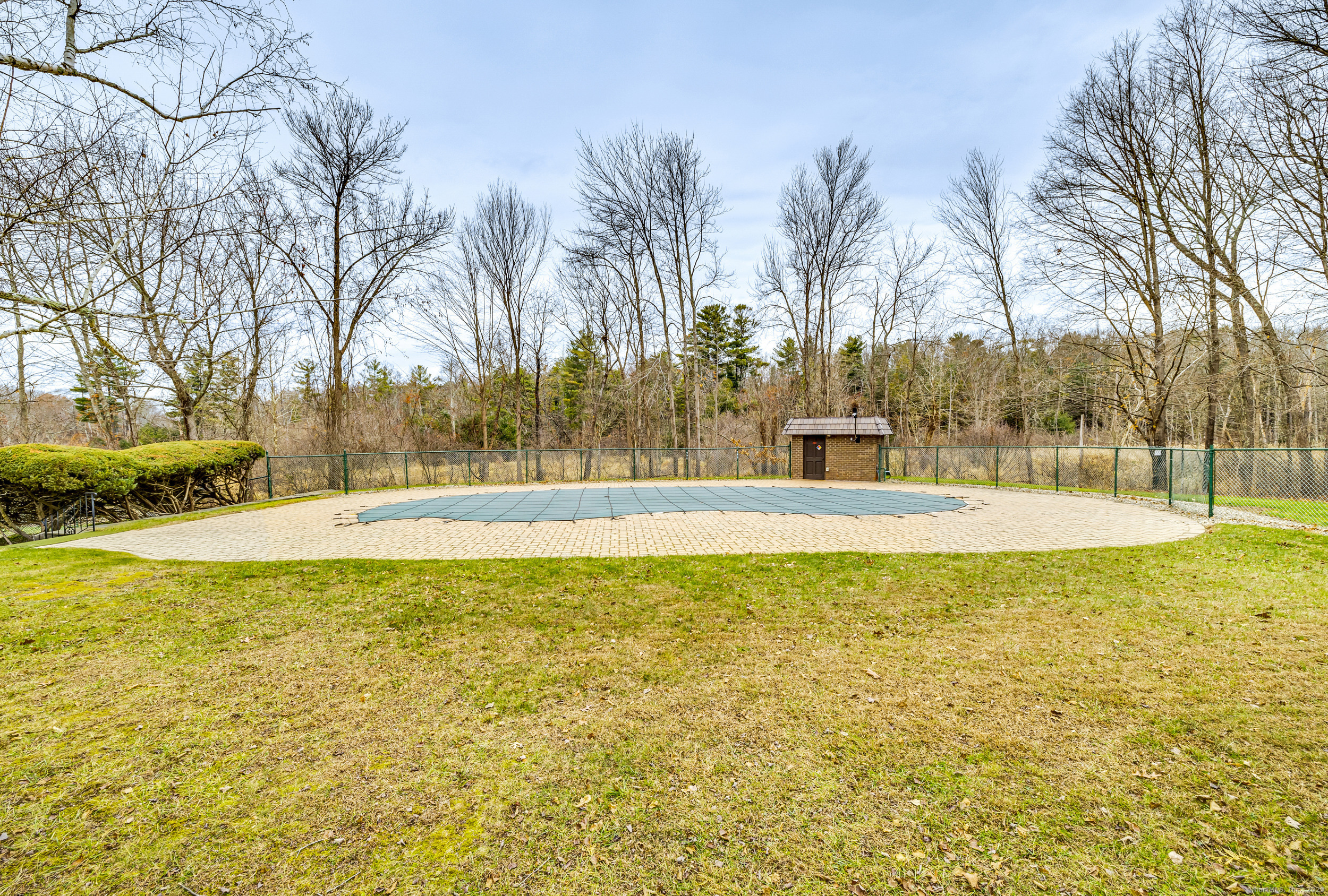 38 Rambling Brook Lane, Unit A2 Glastonbury, CT 06033 - Photo 22 of 23 a swimming pool that has lawn chairs under an umbrella