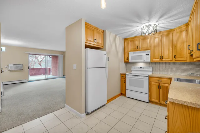 a kitchen with stainless steel appliances granite countertop a refrigerator sink and stove