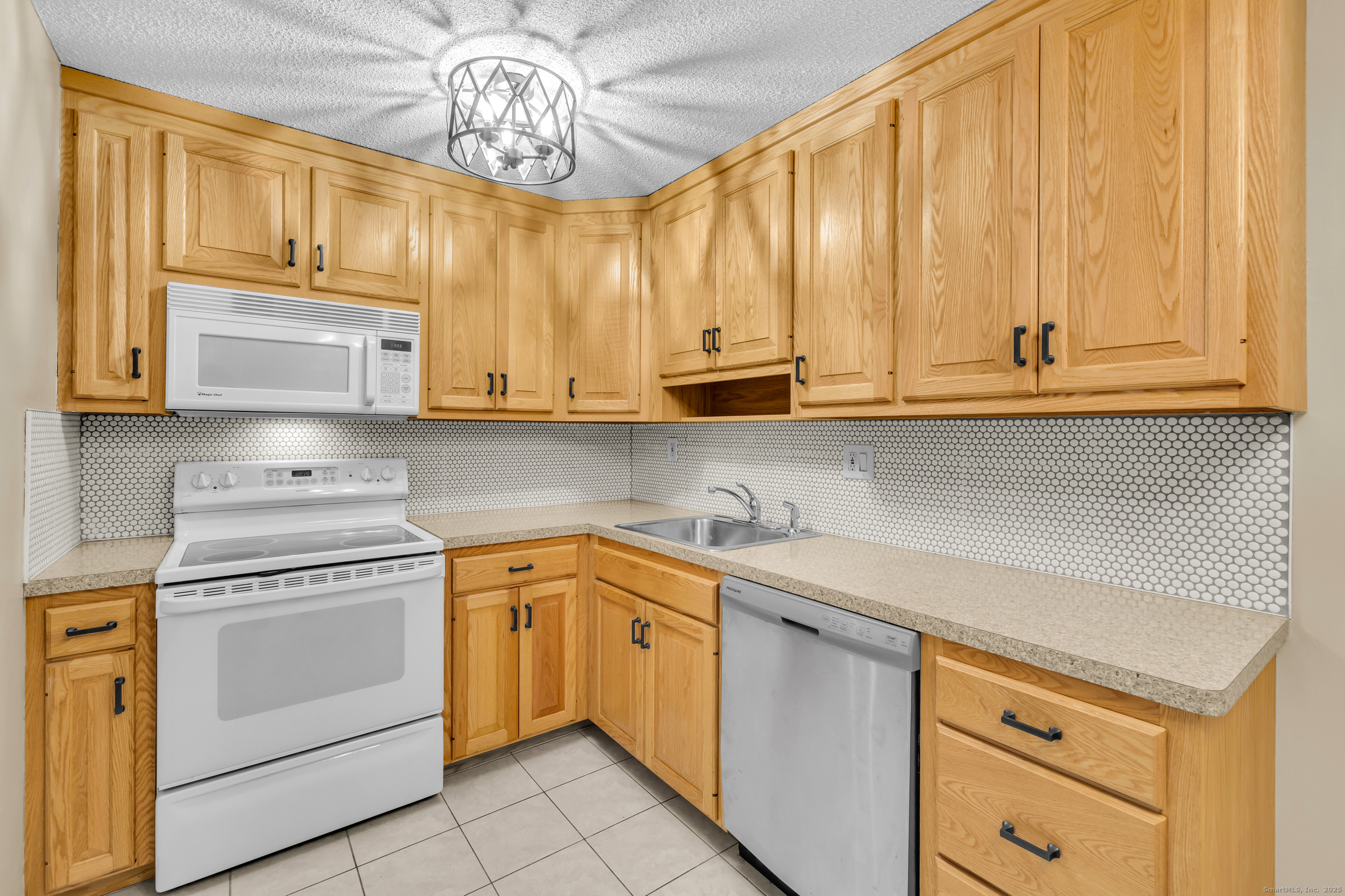 38 Rambling Brook Lane, Unit A2 Glastonbury, CT 06033 - Photo 9 of 23 a kitchen with stainless steel appliances granite countertop a stove a sink dishwasher and cabinets with wooden floor