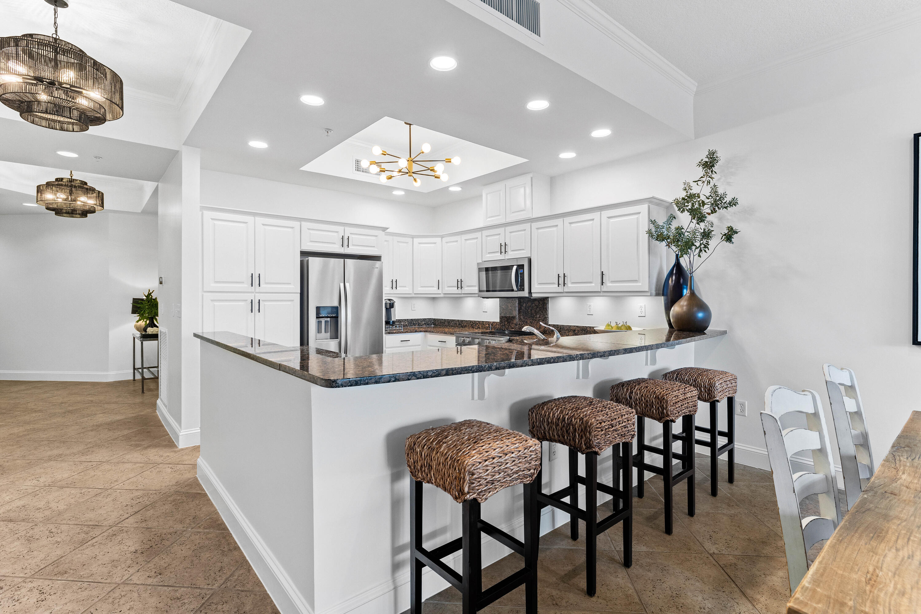 9961 East County Highway 30A, Unit 205 Inlet Beach, FL 32461 - Photo 18 of 45 a kitchen with kitchen island granite countertop stainless steel appliances a table and chairs in it