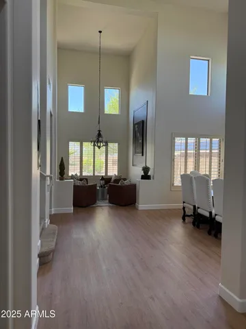 a living room with furniture and a chandelier