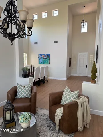 a living room with furniture and a chandelier