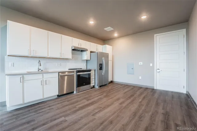 a kitchen with a sink and steel stainless steel appliances