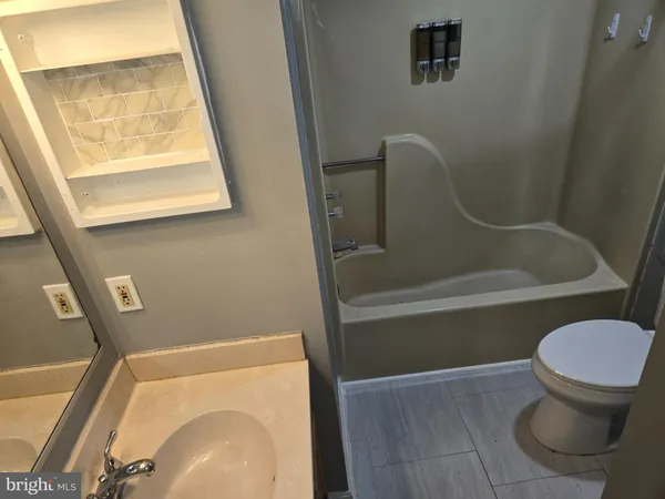 a bathroom with a toilet and a sink