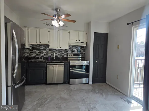 a kitchen with stainless steel appliances granite countertop a stove and a refrigerator