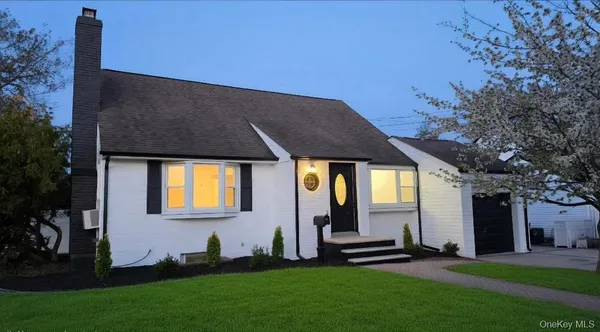 a front view of a house with a garden and yard