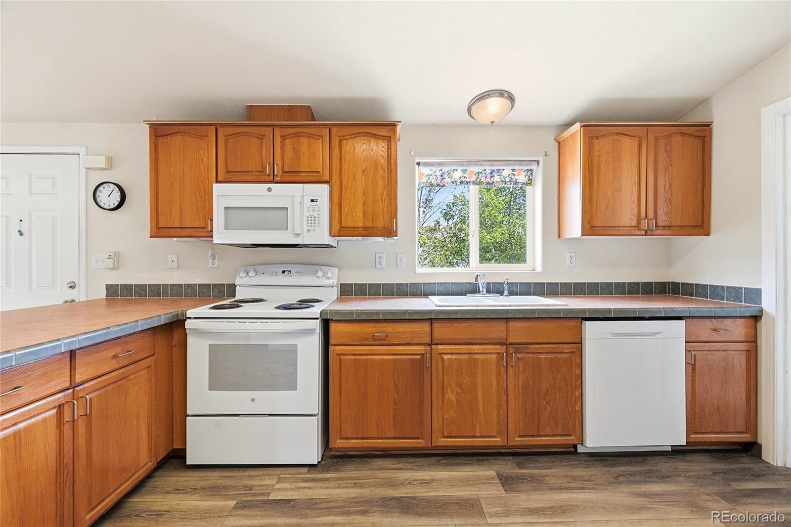 20300 Old Ranch Loop Nathrop, CO 81236 - Photo 6 of 35 a kitchen with stainless steel appliances granite countertop a stove a sink and a microwave