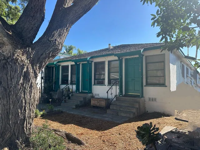 a front view of a house with outdoor seating