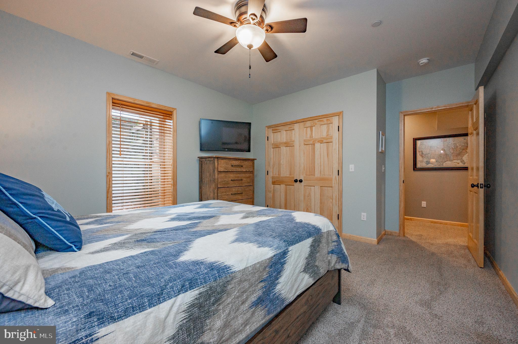 226 Wisp Adventure Road McHenry, MD 21541 - Photo 26 of 67 a bedroom with a bed and a chandelier