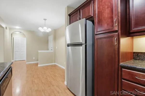 a kitchen with stainless steel appliances a refrigerator and cabinets