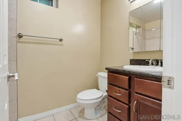 a bathroom with a toilet a sink and vanity