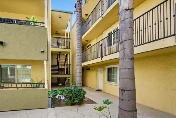 a front view of a building with a garden