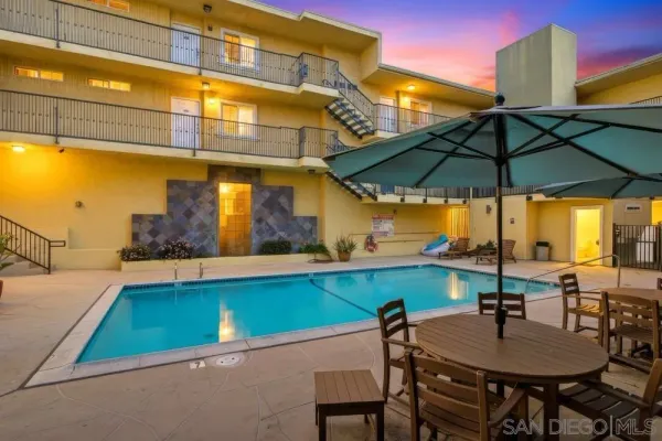 a view of an outdoor space with furniture and umbrella