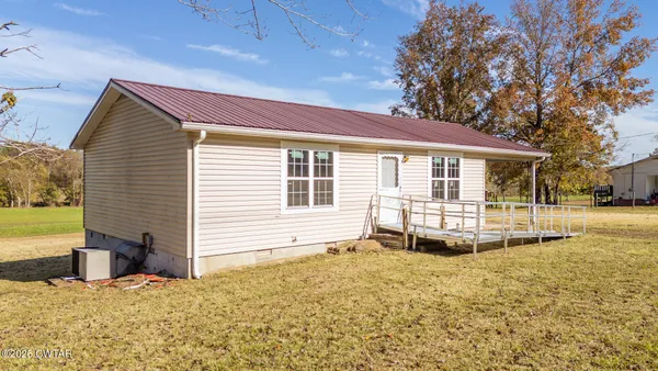 a view of a house with a snow in the yard
