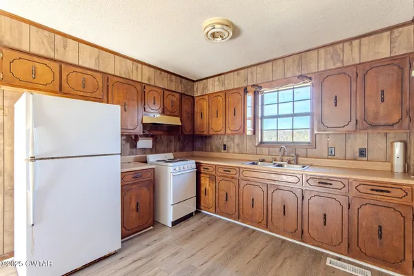 a kitchen with stainless steel appliances granite countertop a refrigerator sink and cabinets
