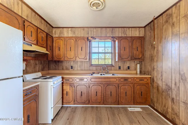 a kitchen with cabinets a sink and appliances